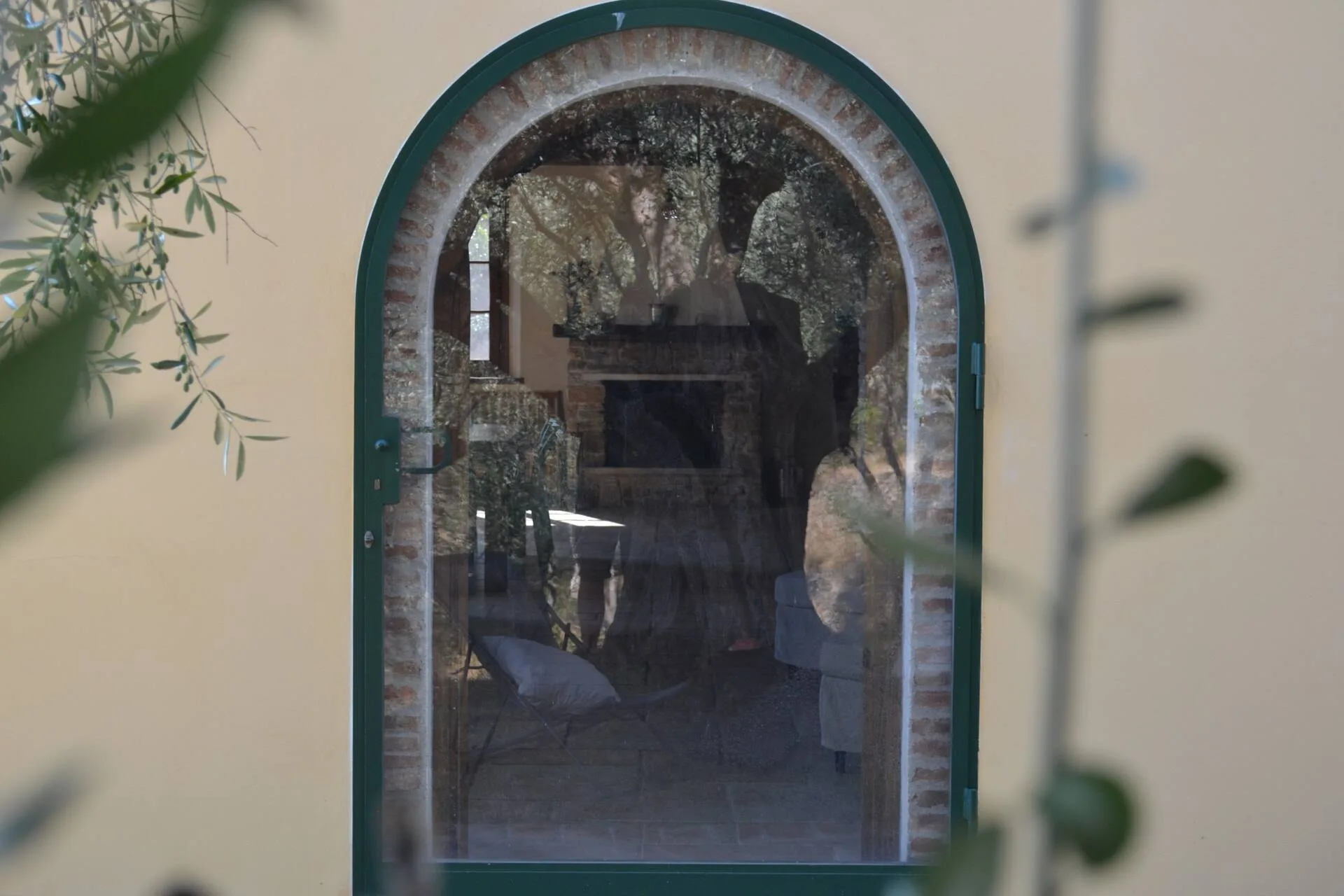 Arched stone doorway leading to the outdoor kitchen nook
