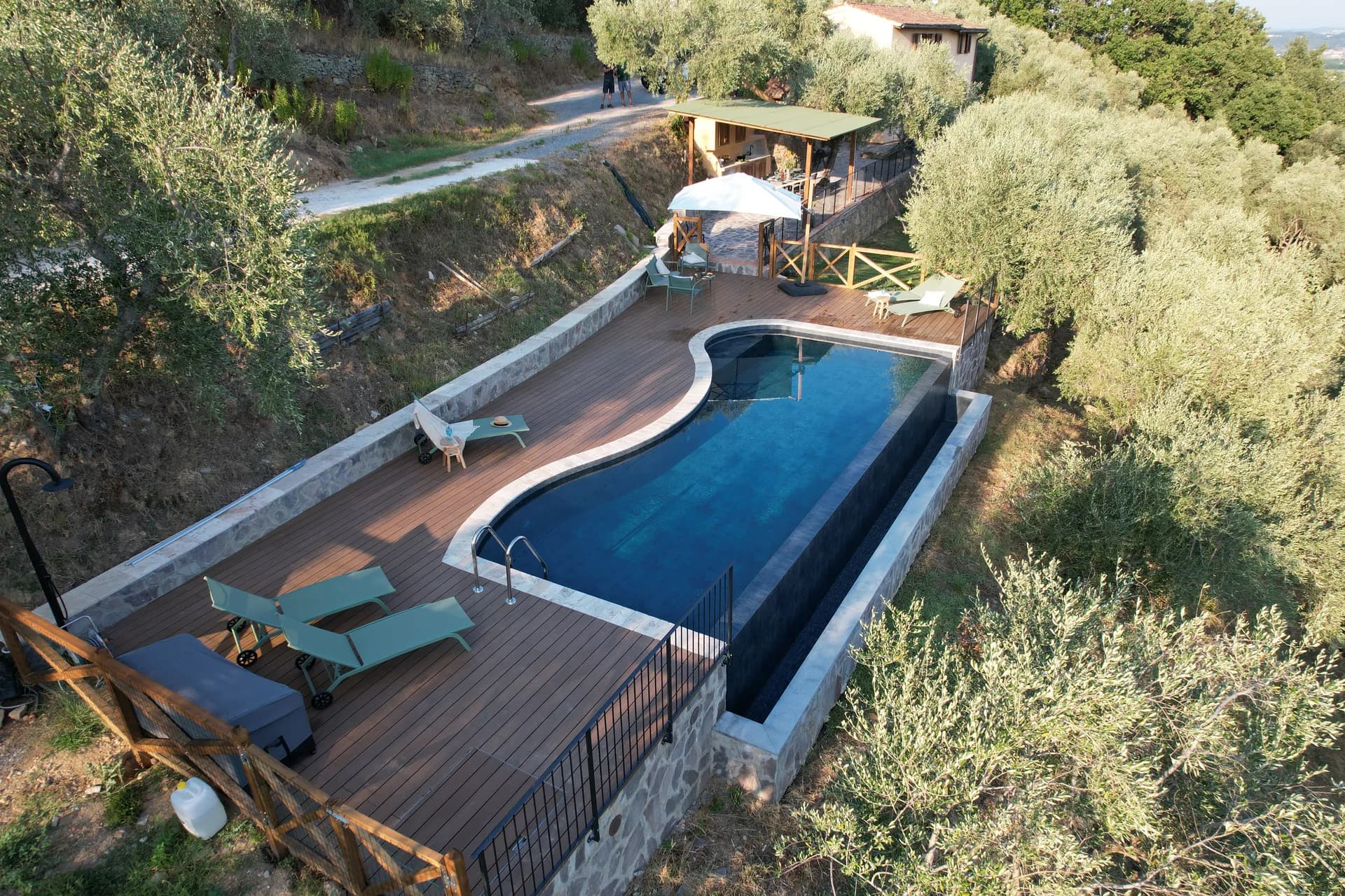 The shaded gazebo and outdoor kitchen beside the pool