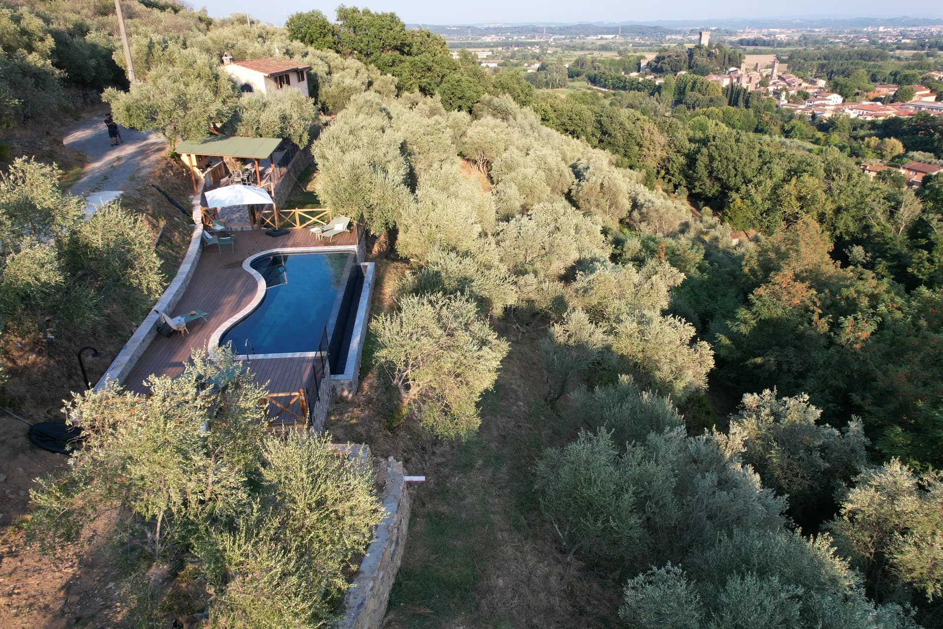 The shaded gazebo and outdoor kitchen beside the pool