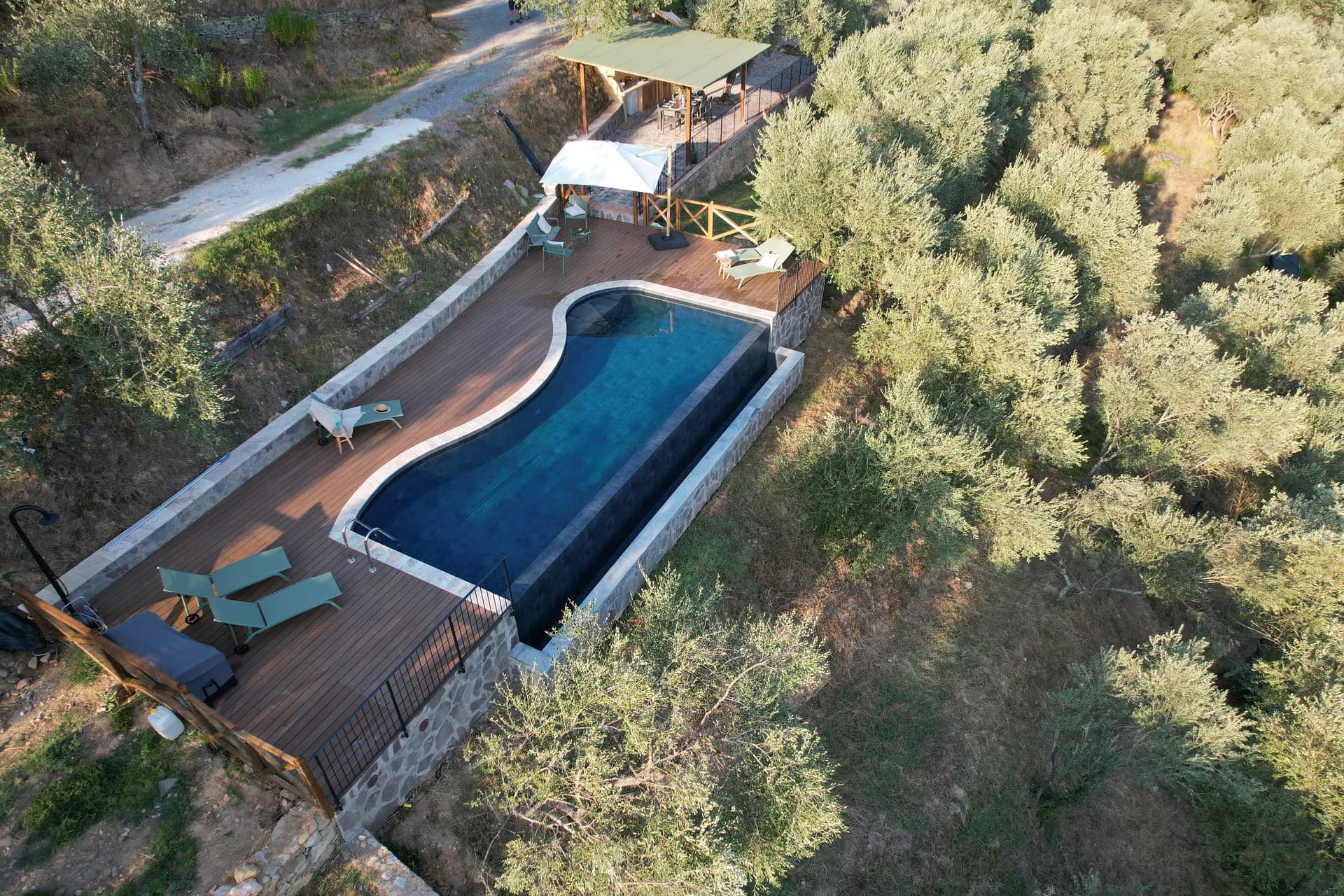 The shaded gazebo and outdoor kitchen beside the pool