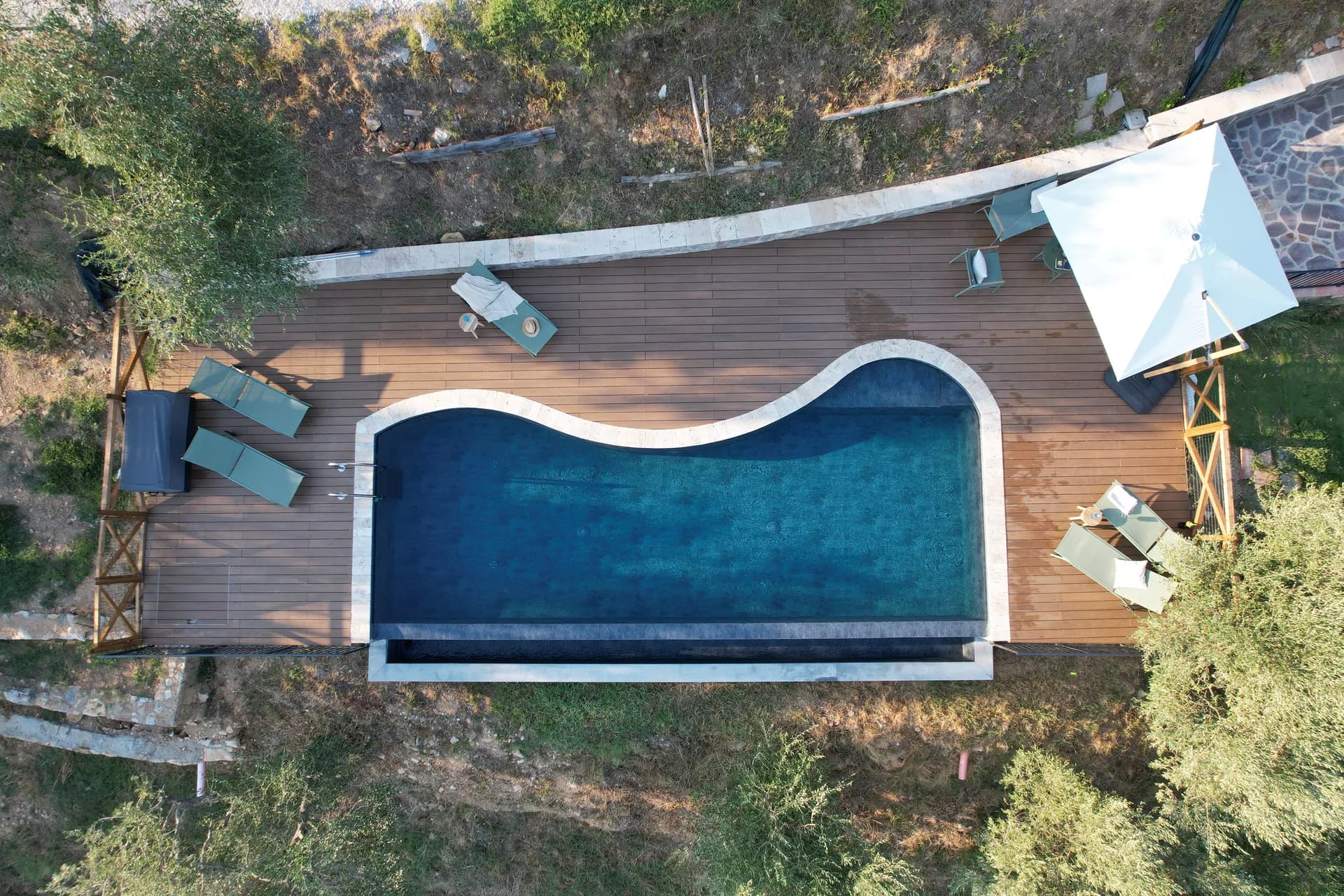 The pool deck and loungers at Casale Eleo
