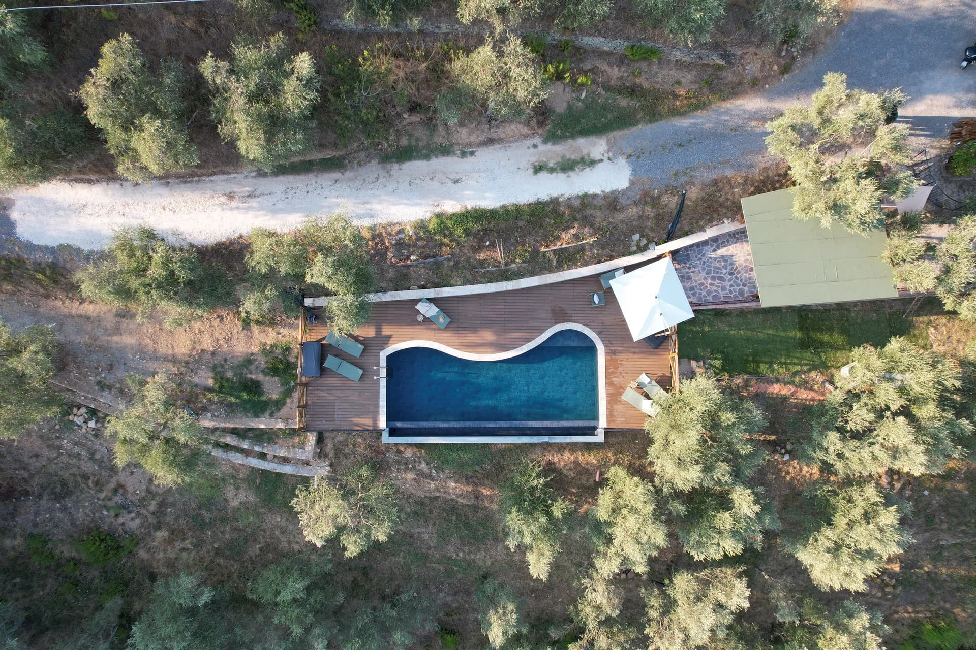 The shaded gazebo and outdoor kitchen beside the pool