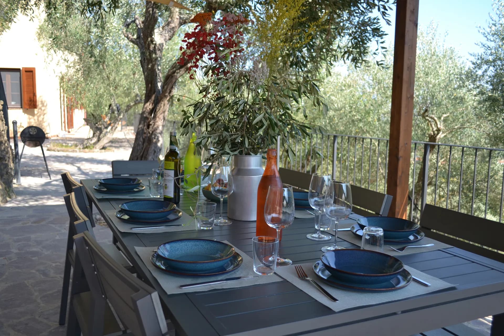 A table laid for dinner under the gazebo at Casale Eleo