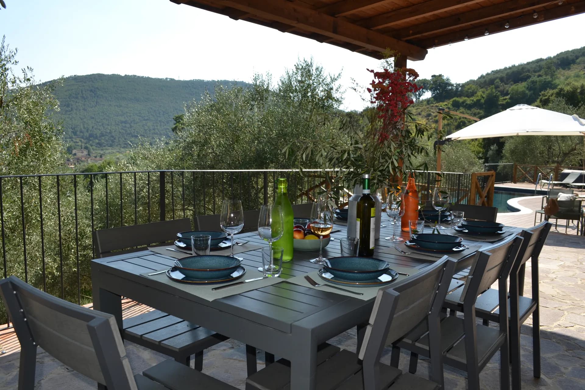 A table laid for dinner under the gazebo at Casale Eleo