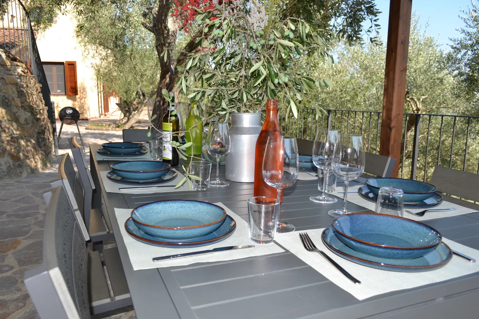 A table laid for dinner under the gazebo at Casale Eleo