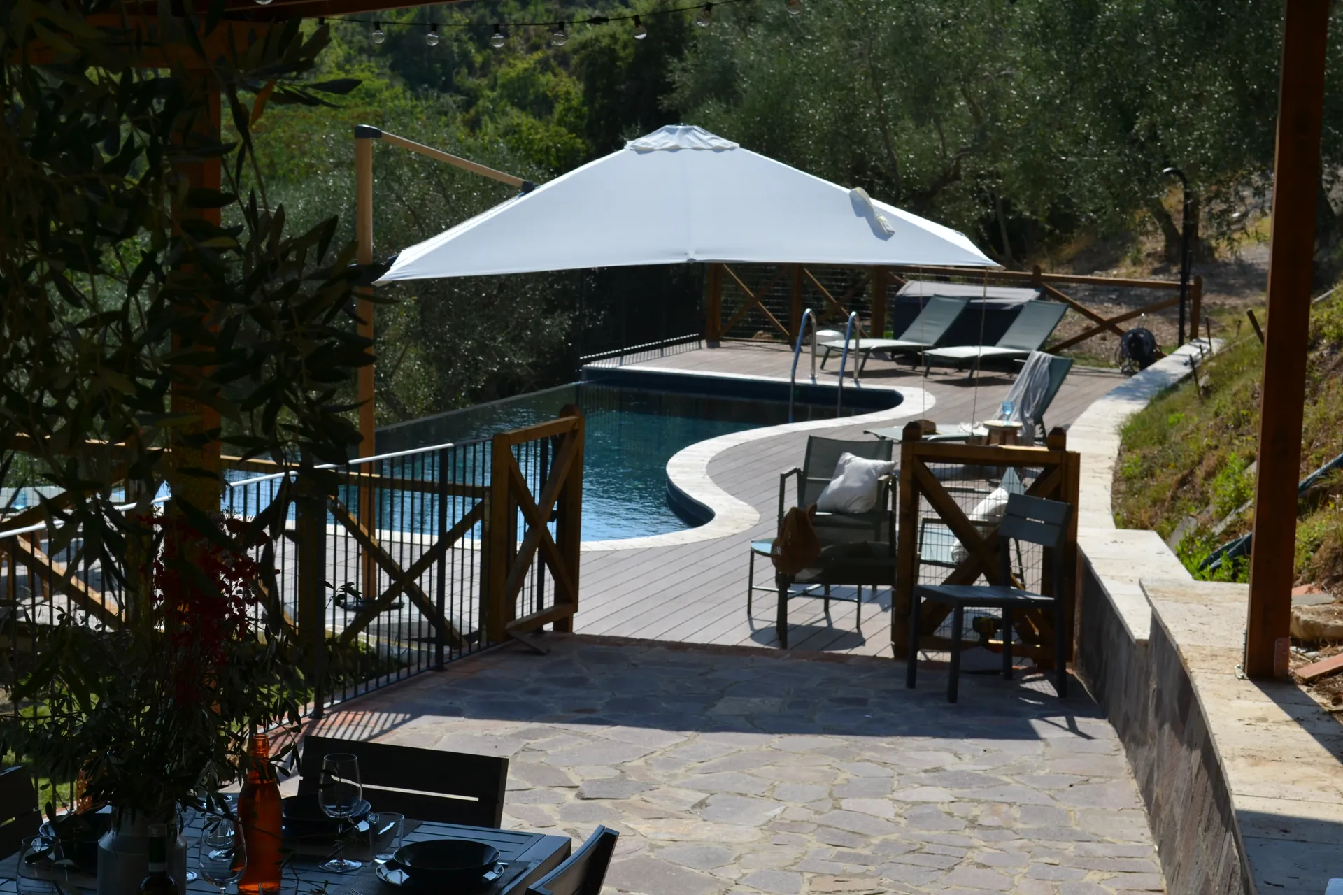 The shaded gazebo and outdoor kitchen beside the pool