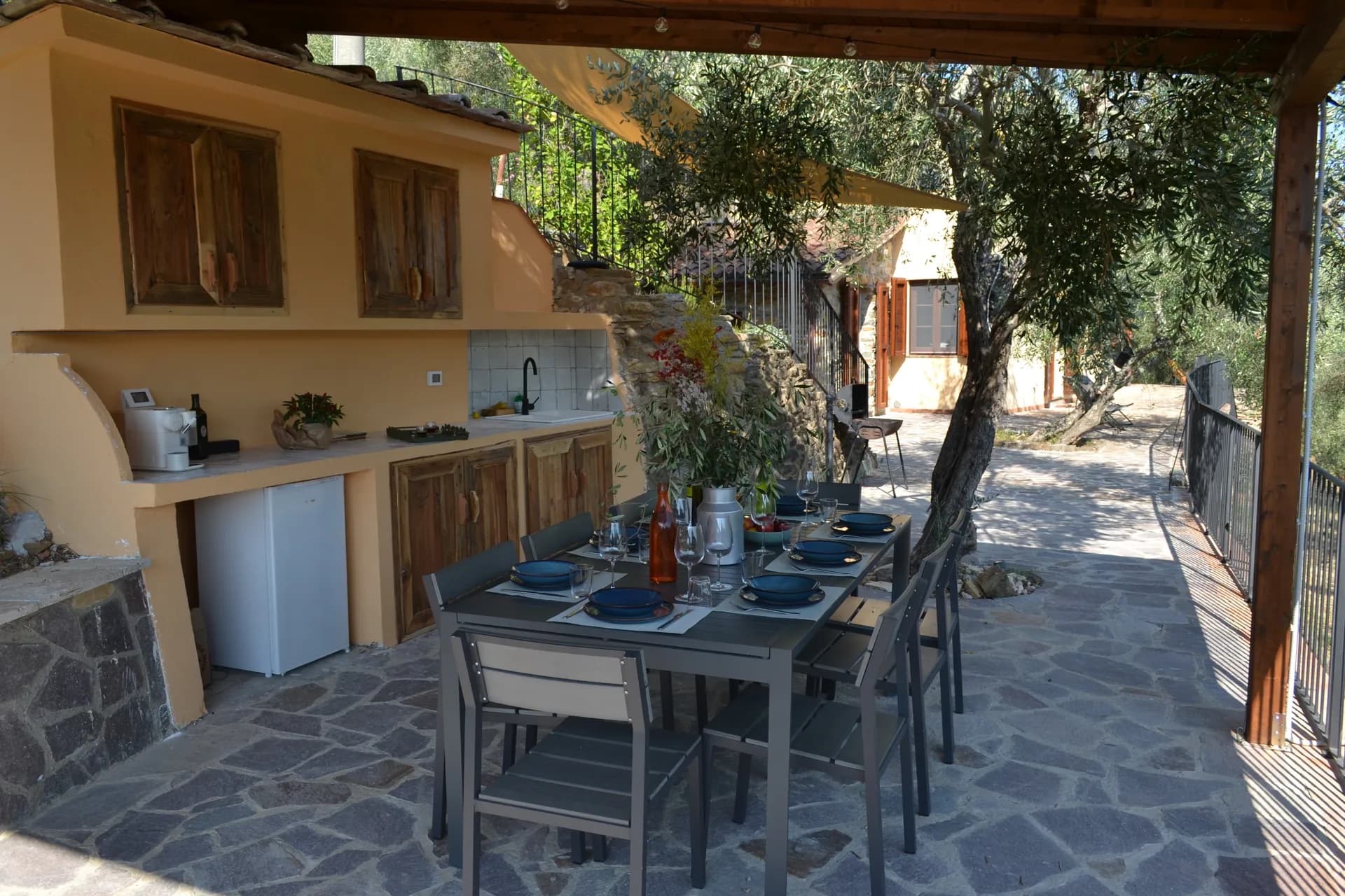 A table laid for dinner under the gazebo at Casale Eleo