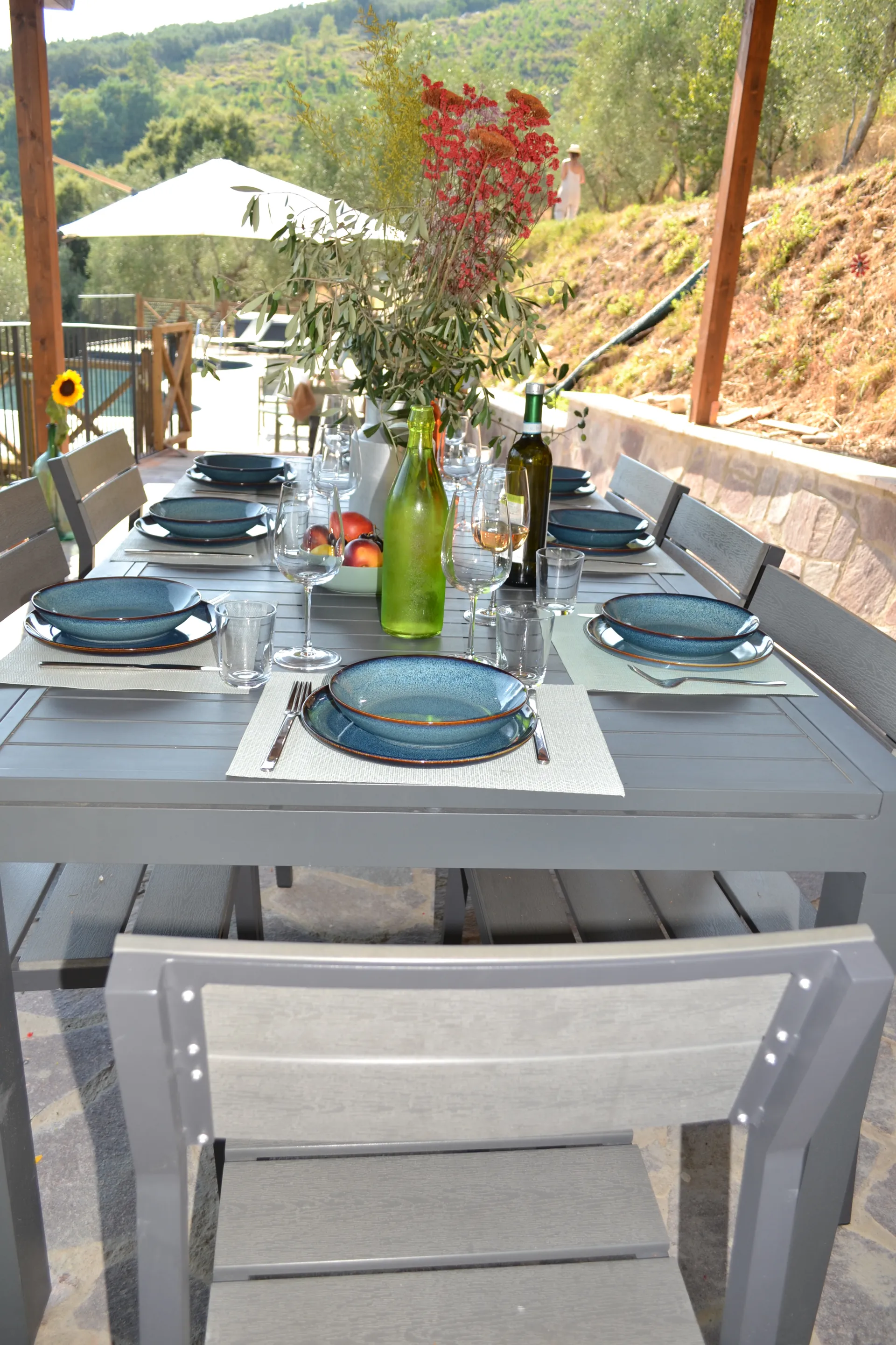 A table laid for dinner under the gazebo at Casale Eleo