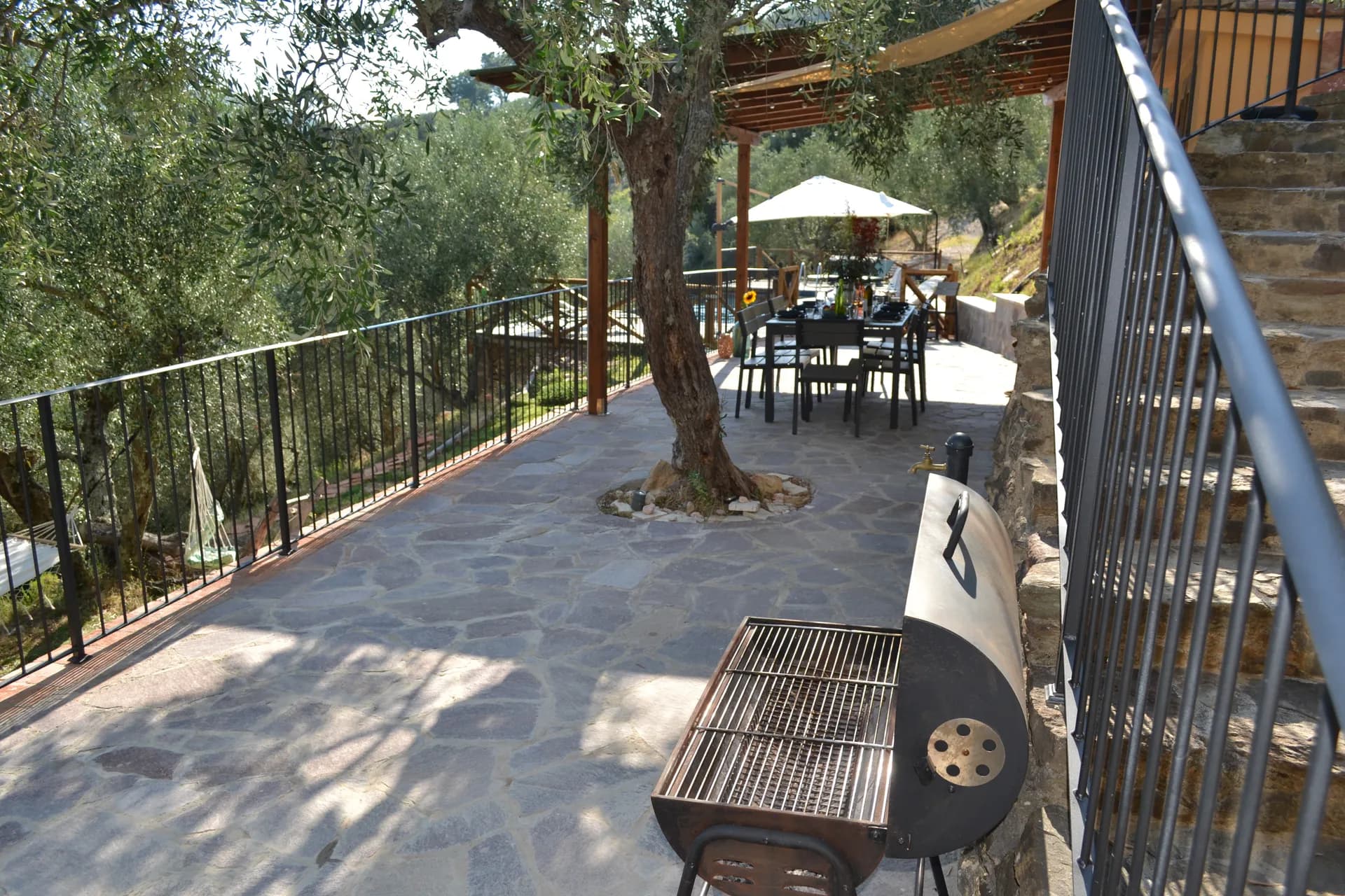 The shaded gazebo and outdoor kitchen beside the pool