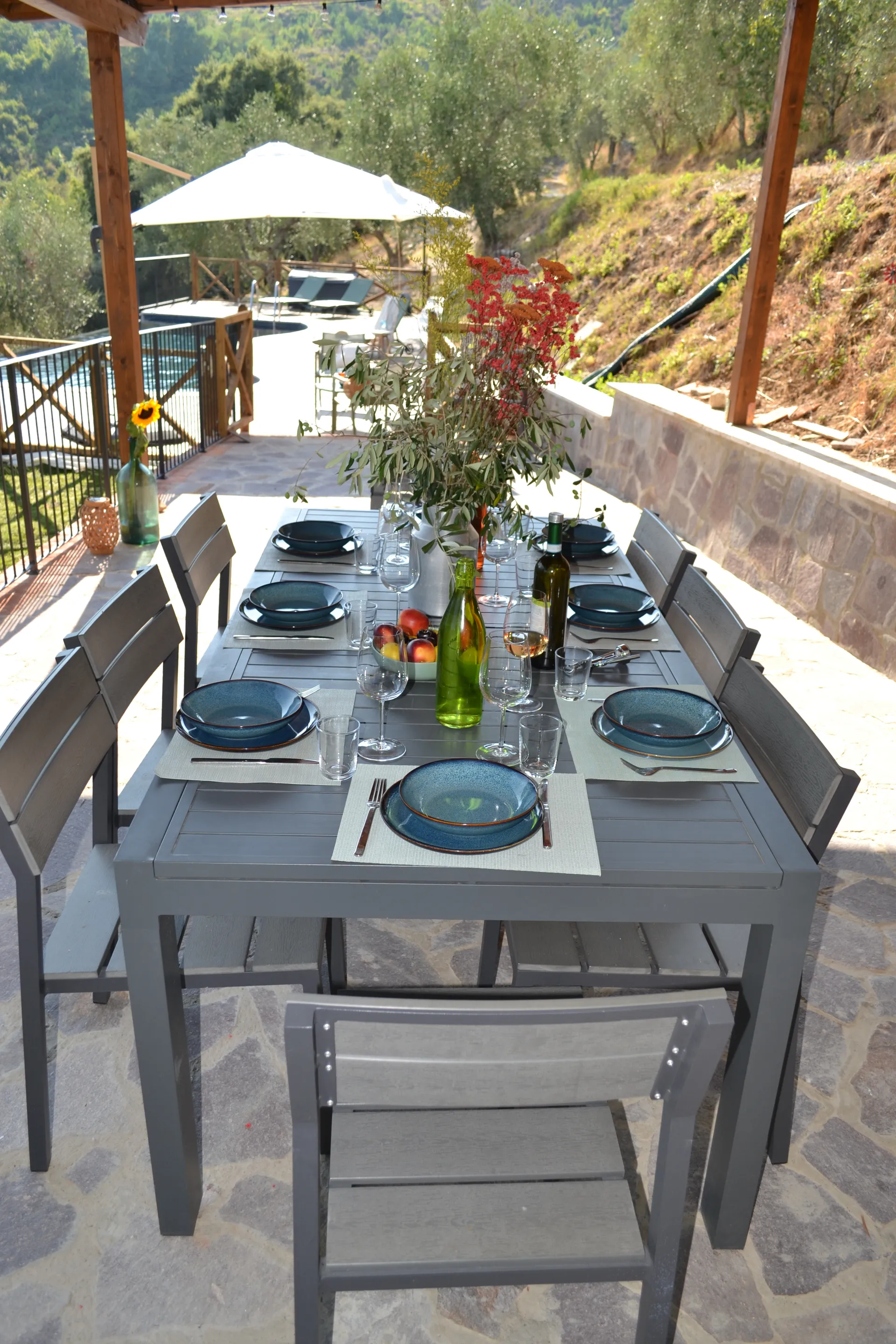 A table laid for dinner under the gazebo at Casale Eleo