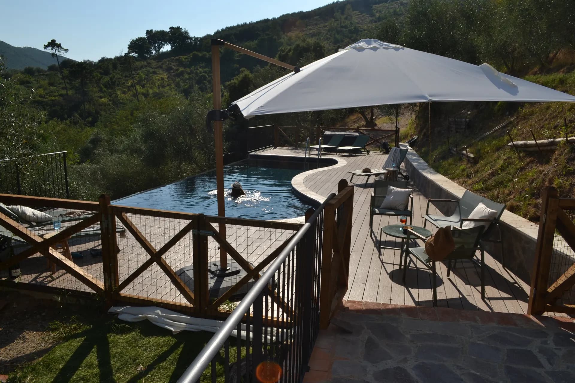 The shaded gazebo and outdoor kitchen beside the pool