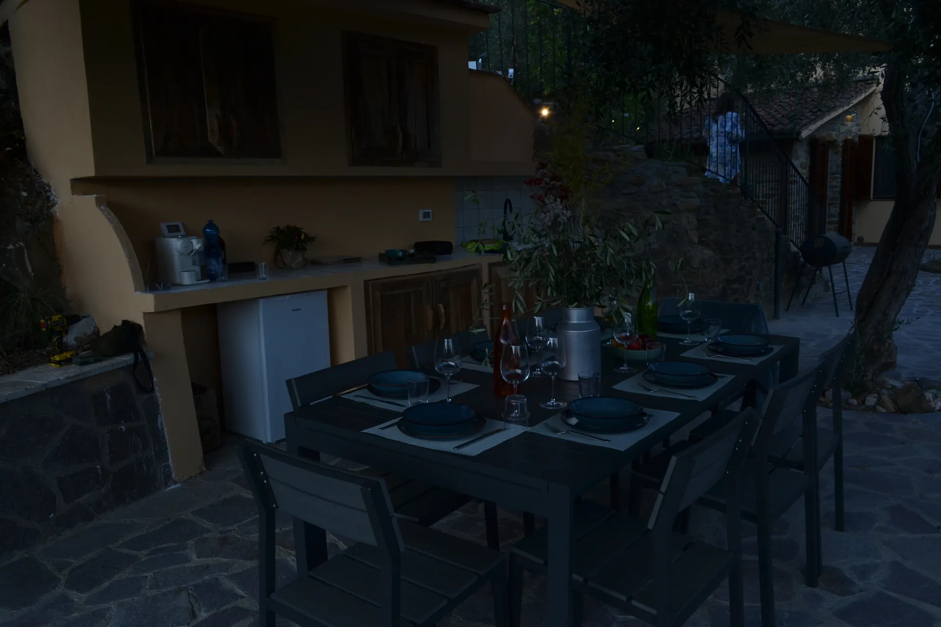 A table laid for dinner under the gazebo at Casale Eleo