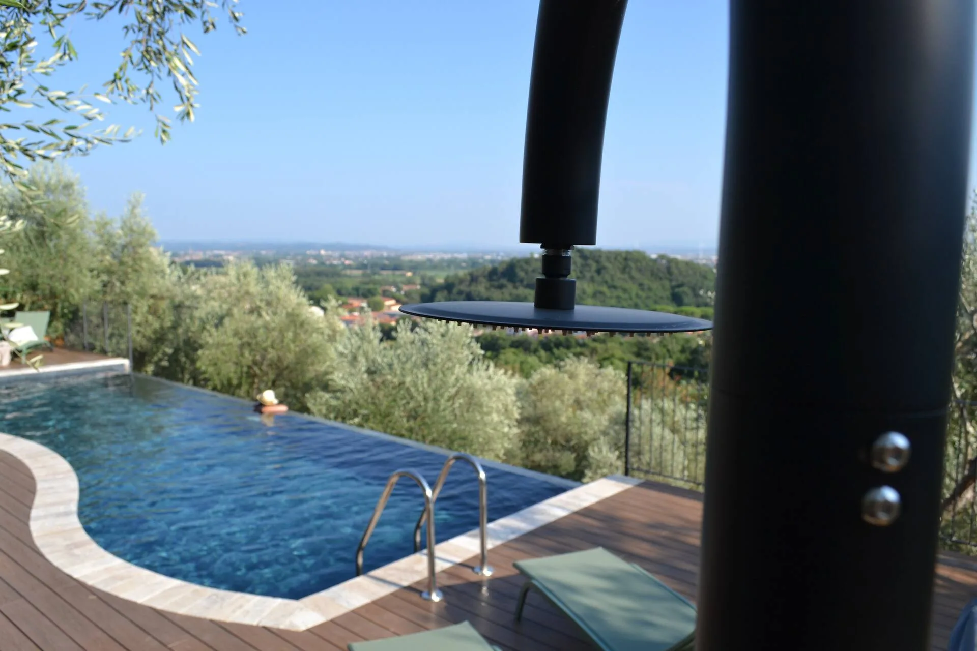 A guest swimming in the infinity pool beside the safety gate