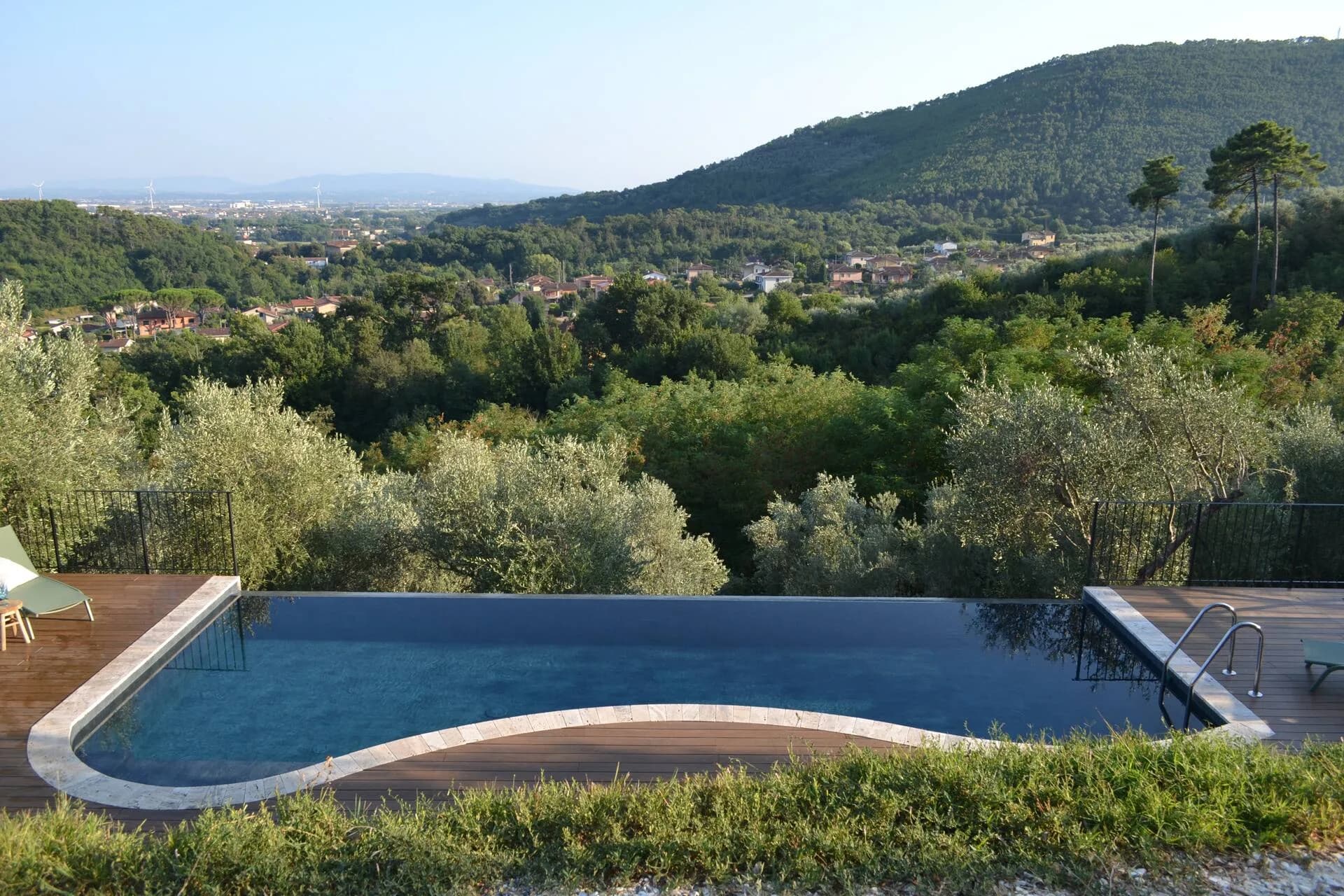 Wide aerial view of the curved infinity pool and sundeck